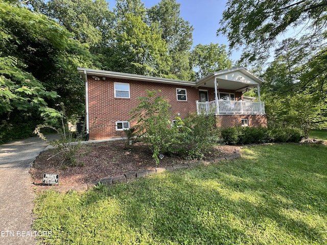 111 Old Evacuation Ln, Oliver Springs, TN 37840 - view of property exterior with brick siding, a lawn, and covered porch
