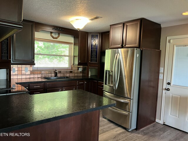 111 Old Evacuation Ln, Oliver Springs, TN 37840 - kitchen featuring a sink, dark countertops, stainless steel refrigerator with ice dispenser, wood finished floors, and tasteful backsplash