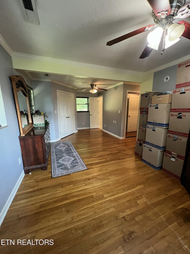 111 Old Evacuation Ln, Oliver Springs, TN 37840 - unfurnished bedroom with ornamental molding, wood finished floors, baseboards, a ceiling fan, and a textured ceiling
