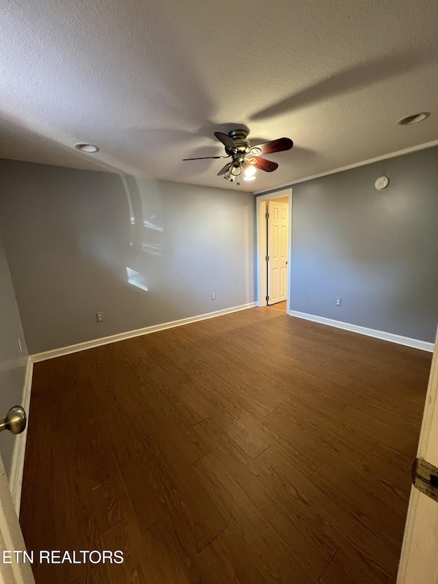 111 Old Evacuation Ln, Oliver Springs, TN 37840 - empty room with wood finished floors, a ceiling fan, a textured ceiling, and baseboards