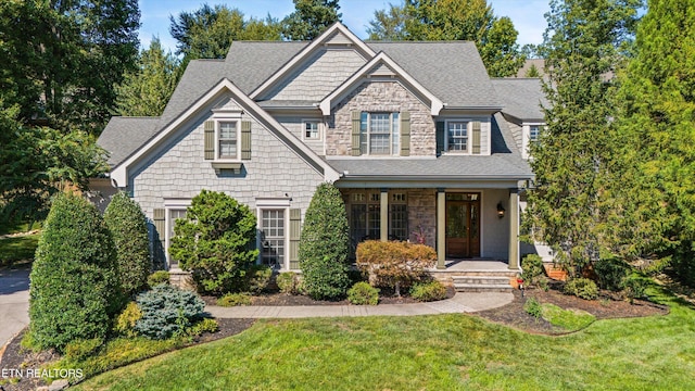 view of front of home featuring a porch and a front lawn