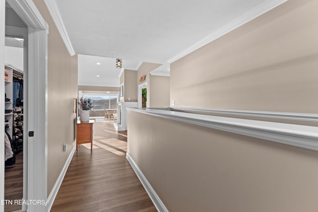 corridor with hardwood / wood-style flooring and ornamental molding