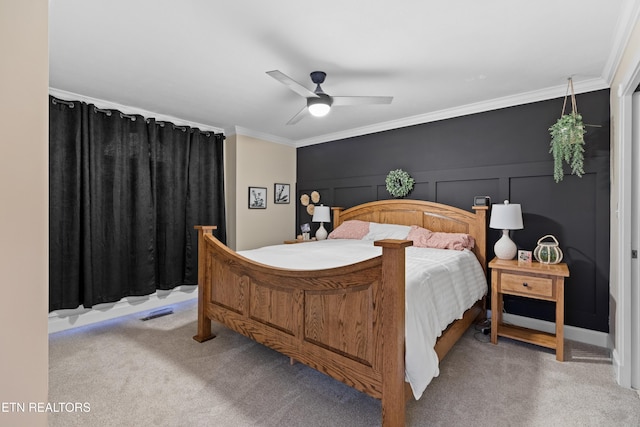 bedroom featuring ornamental molding, ceiling fan, and carpet