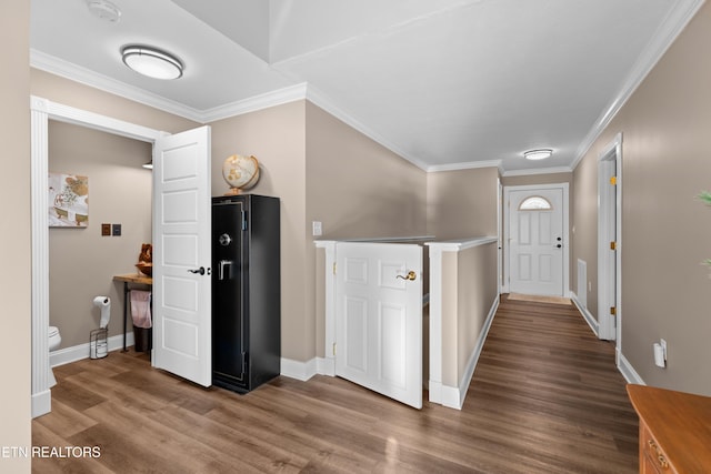 corridor with hardwood / wood-style floors and ornamental molding