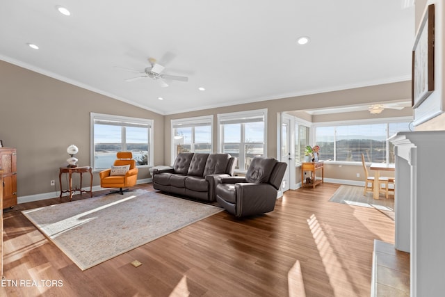 living room featuring lofted ceiling, crown molding, ceiling fan, and light wood-type flooring