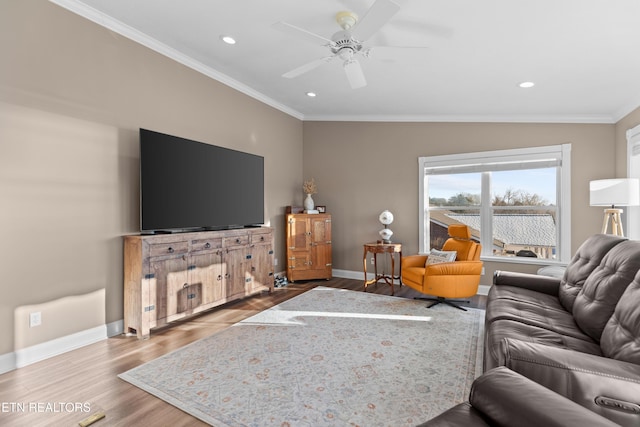 living room featuring hardwood / wood-style floors, ornamental molding, and ceiling fan