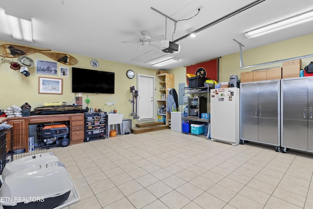 garage featuring a garage door opener, ceiling fan, and white fridge