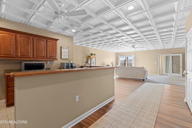 kitchen with ceiling fan and light hardwood / wood-style floors