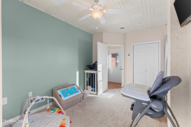 recreation room featuring light carpet and ceiling fan