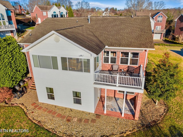 back of property featuring a patio and a balcony