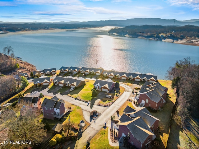 drone / aerial view with a water and mountain view