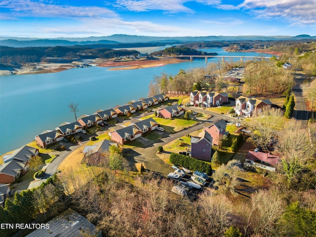 drone / aerial view featuring a water and mountain view