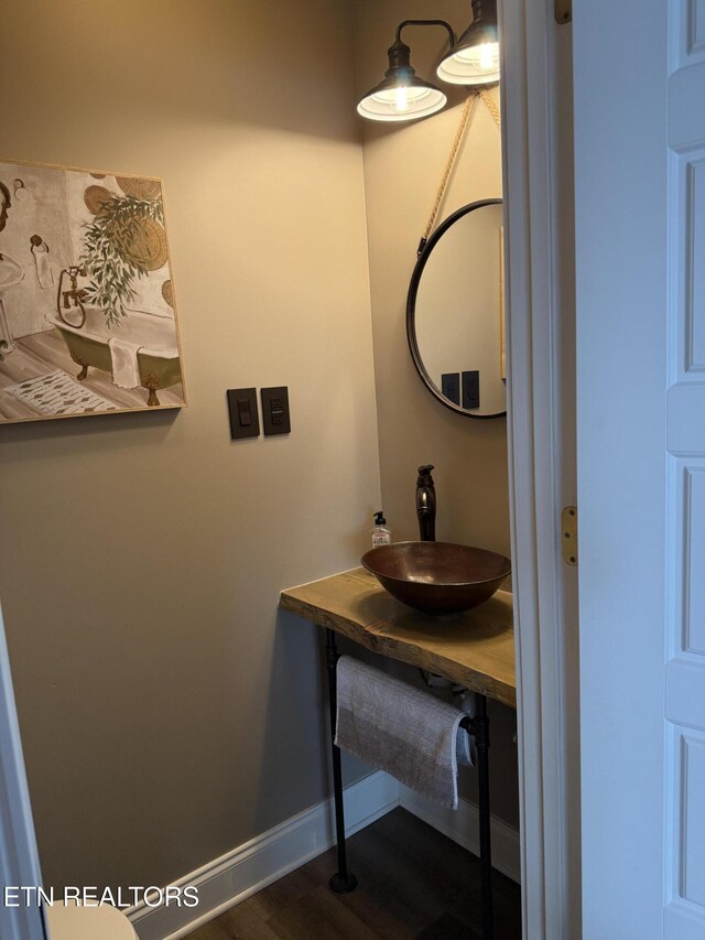 1241 Bennington Way, Dandridge, TN 37725 - bathroom featuring baseboards, wood finished floors, and a sink