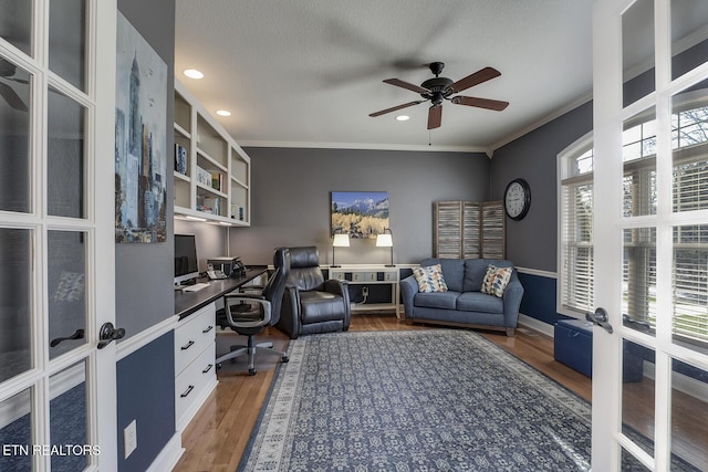 office with ceiling fan, built in study area, wood finished floors, crown molding, and recessed lighting