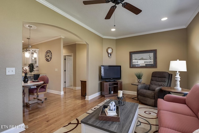 living area with arched walkways, light wood finished floors, ceiling fan, recessed lighting, and baseboards