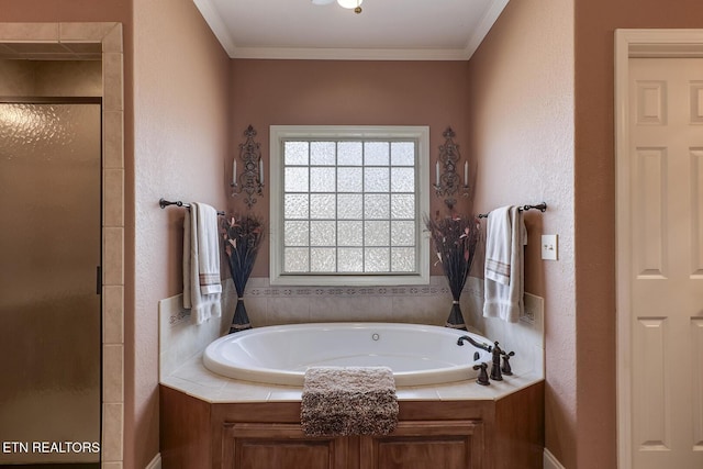 full bathroom featuring a shower stall, a garden tub, crown molding, and a textured wall