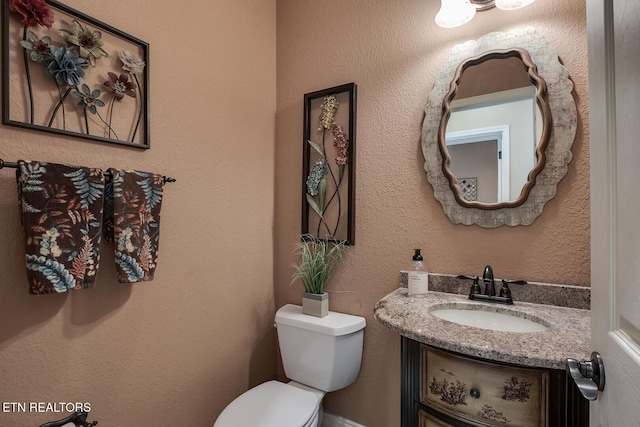 bathroom with toilet and vanity