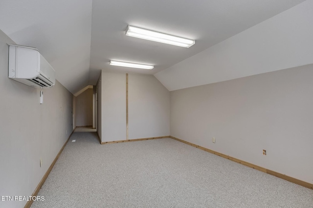 additional living space with vaulted ceiling, light carpet, and baseboards