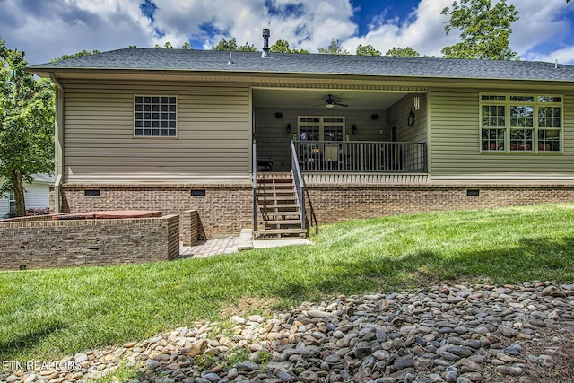 back of house with crawl space, a lawn, a ceiling fan, stairs, and roof with shingles