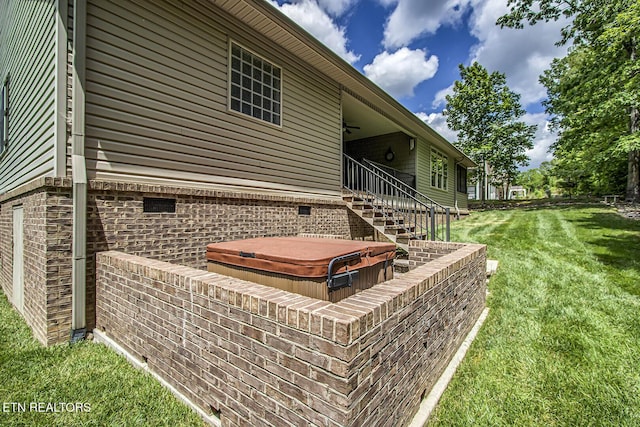 exterior view of a jacuzzi, ceiling fan, and stairs