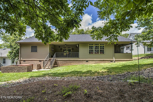 view of front of house with a front lawn, crawl space, stairway, ceiling fan, and a shingled roof