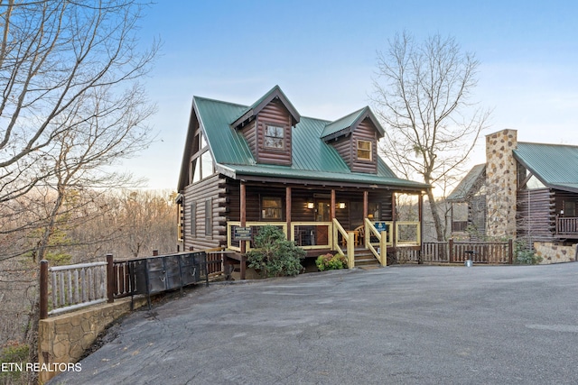 log cabin featuring a porch