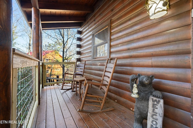 wooden terrace featuring covered porch