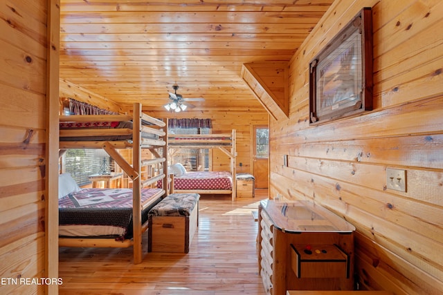 bedroom with hardwood / wood-style flooring, wooden ceiling, and wood walls