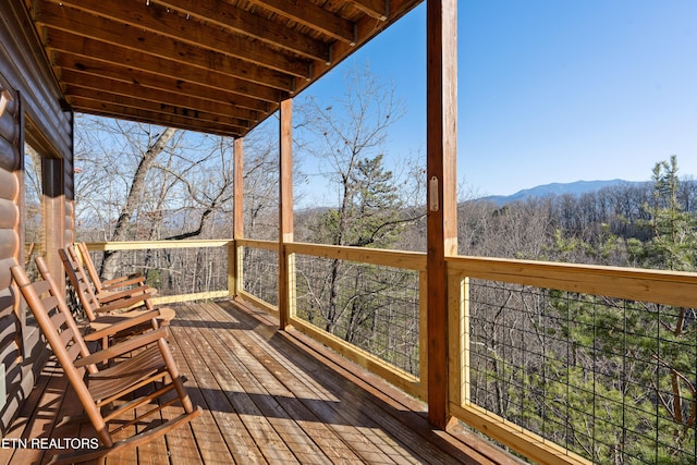 wooden deck with a mountain view