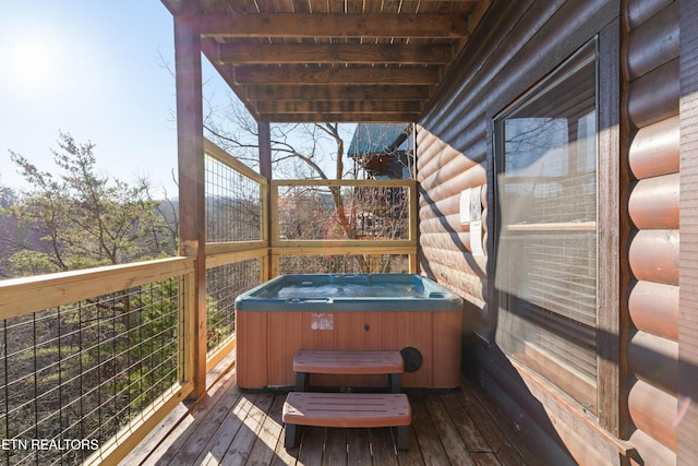 wooden deck with a hot tub