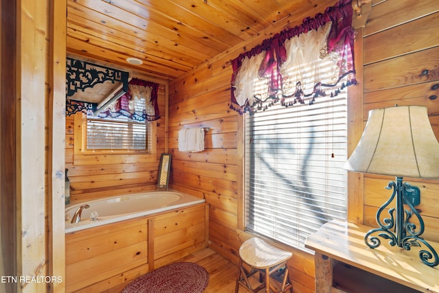 bathroom with wood ceiling, hardwood / wood-style flooring, a bathing tub, and wood walls