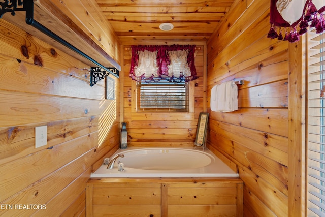 bathroom featuring wooden walls, a washtub, and wooden ceiling