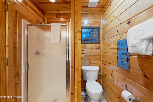 bathroom featuring an enclosed shower, wooden ceiling, toilet, and wood walls