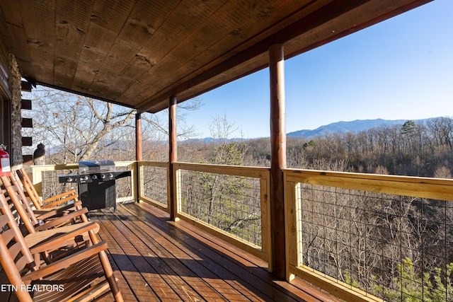 deck with a mountain view and a grill