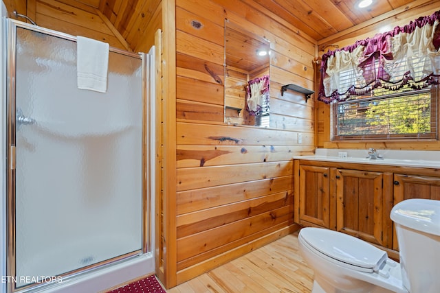 bathroom featuring a shower with door, hardwood / wood-style floors, wooden ceiling, toilet, and wood walls