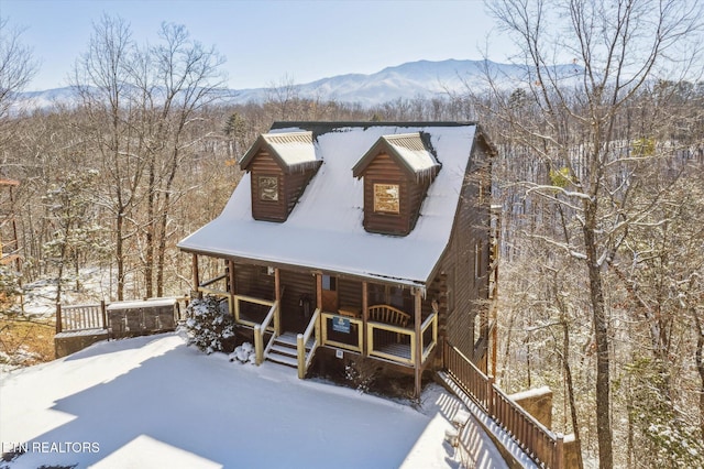 log-style house with a mountain view and covered porch