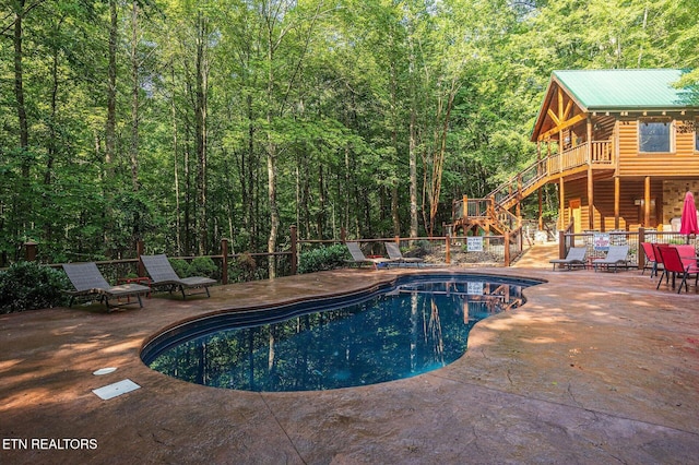 view of swimming pool with a patio area