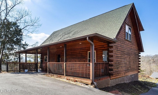 view of side of home featuring a porch