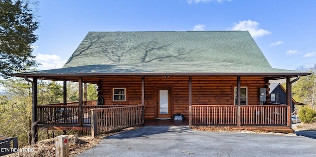 log home featuring a porch