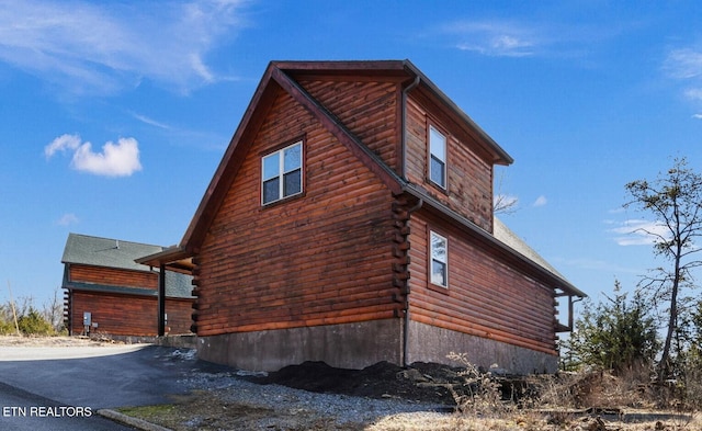 view of side of home featuring log exterior