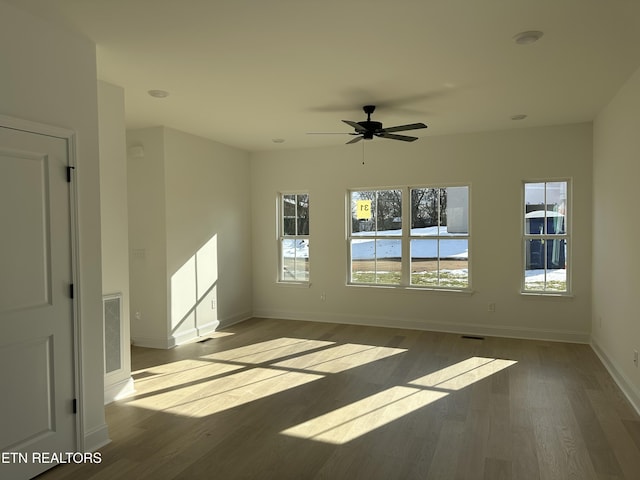 spare room with hardwood / wood-style floors and ceiling fan