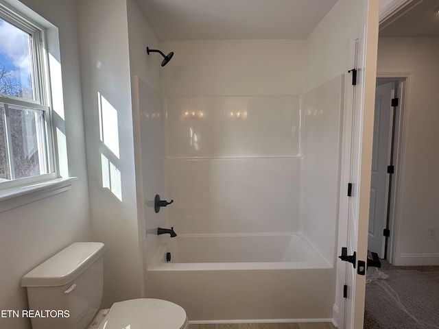 bathroom featuring bathing tub / shower combination and toilet