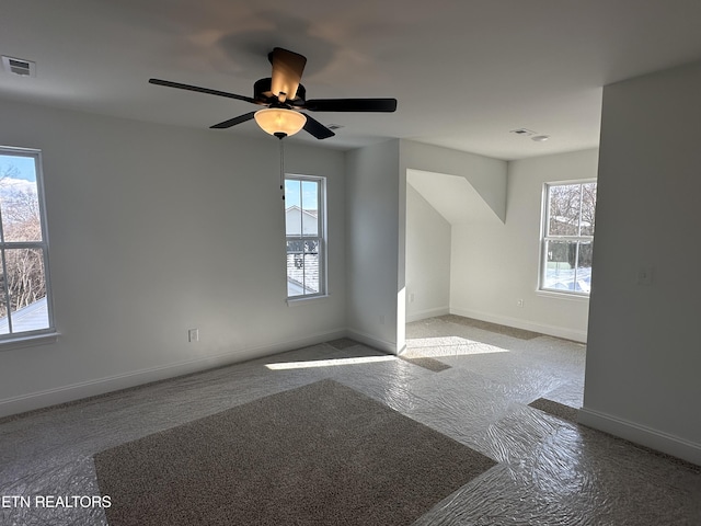 bonus room with ceiling fan and plenty of natural light