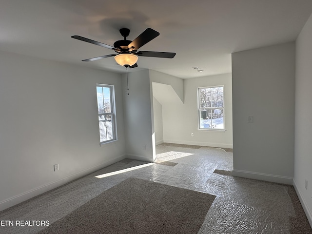 unfurnished room with a healthy amount of sunlight and ceiling fan