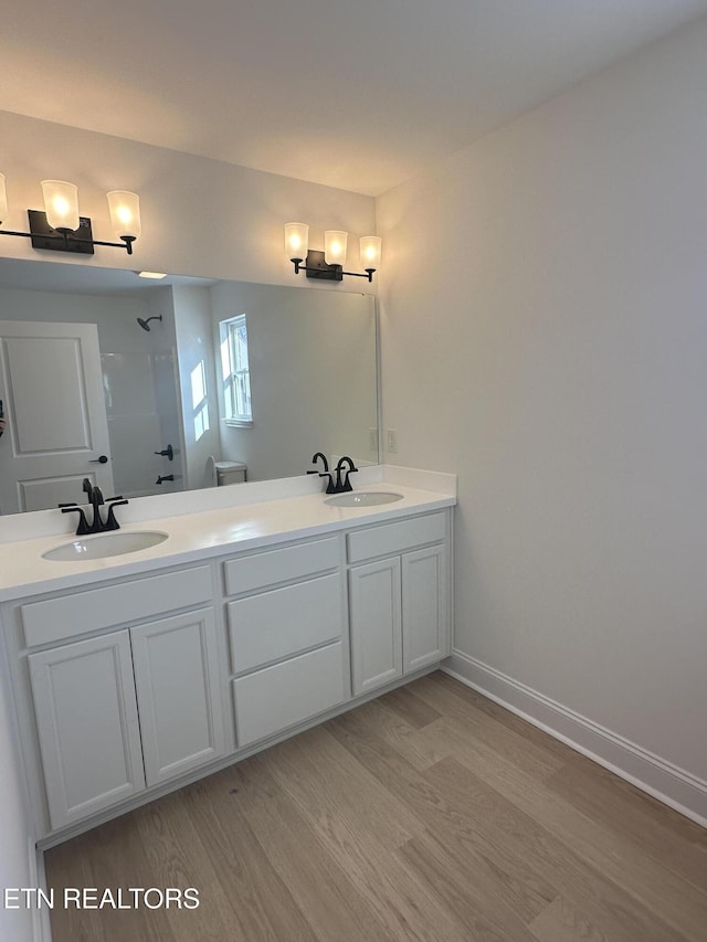 bathroom featuring vanity, hardwood / wood-style flooring, and a shower