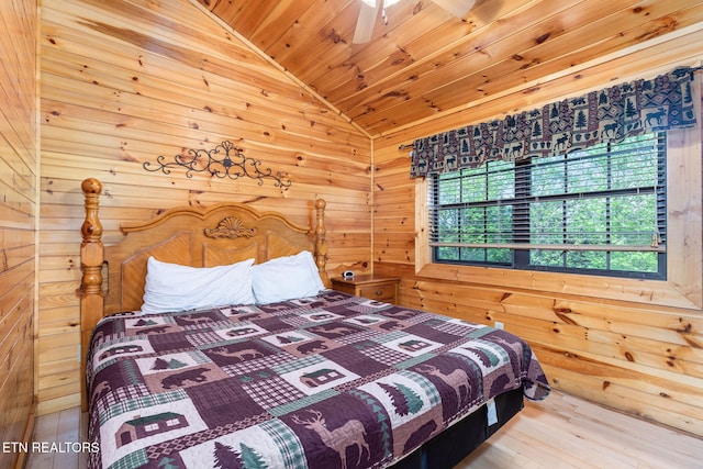 bedroom with wood ceiling, hardwood / wood-style flooring, vaulted ceiling, and wood walls