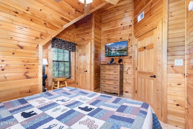 bedroom with wood ceiling, lofted ceiling with beams, and wood walls