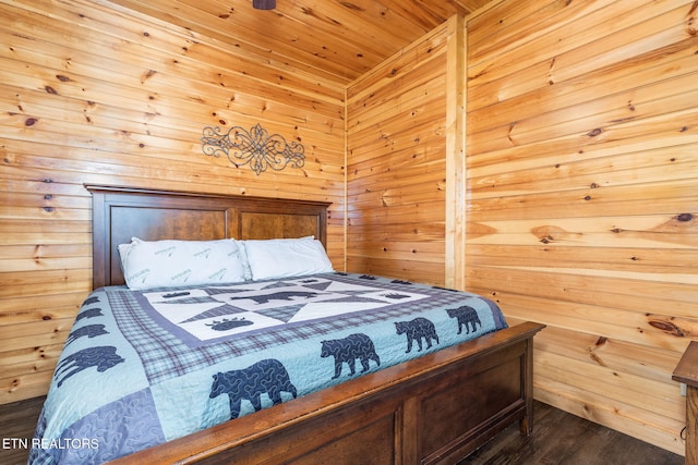 bedroom featuring wood ceiling, dark wood-type flooring, and wooden walls