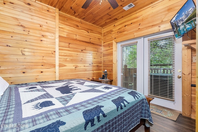 bedroom featuring wood ceiling, wood-type flooring, wooden walls, and access to outside