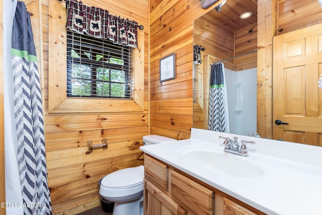 bathroom featuring a shower with curtain, vanity, toilet, and wood walls